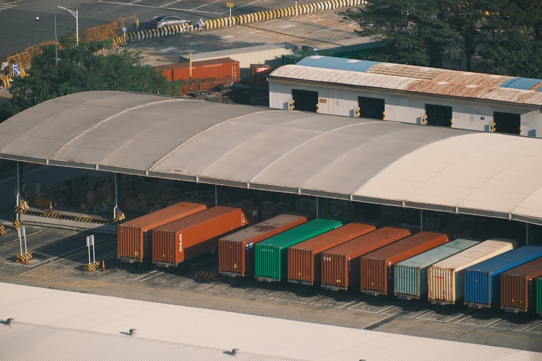 Cargo containers organized in a busy shipping and logistics hub.